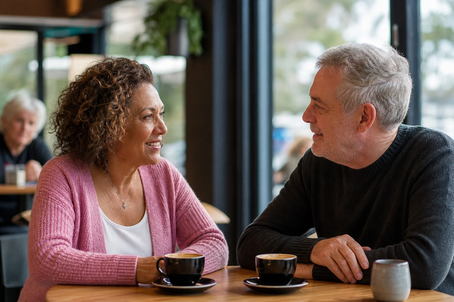 Mature man enjoying a relaxed conversation over coffee
